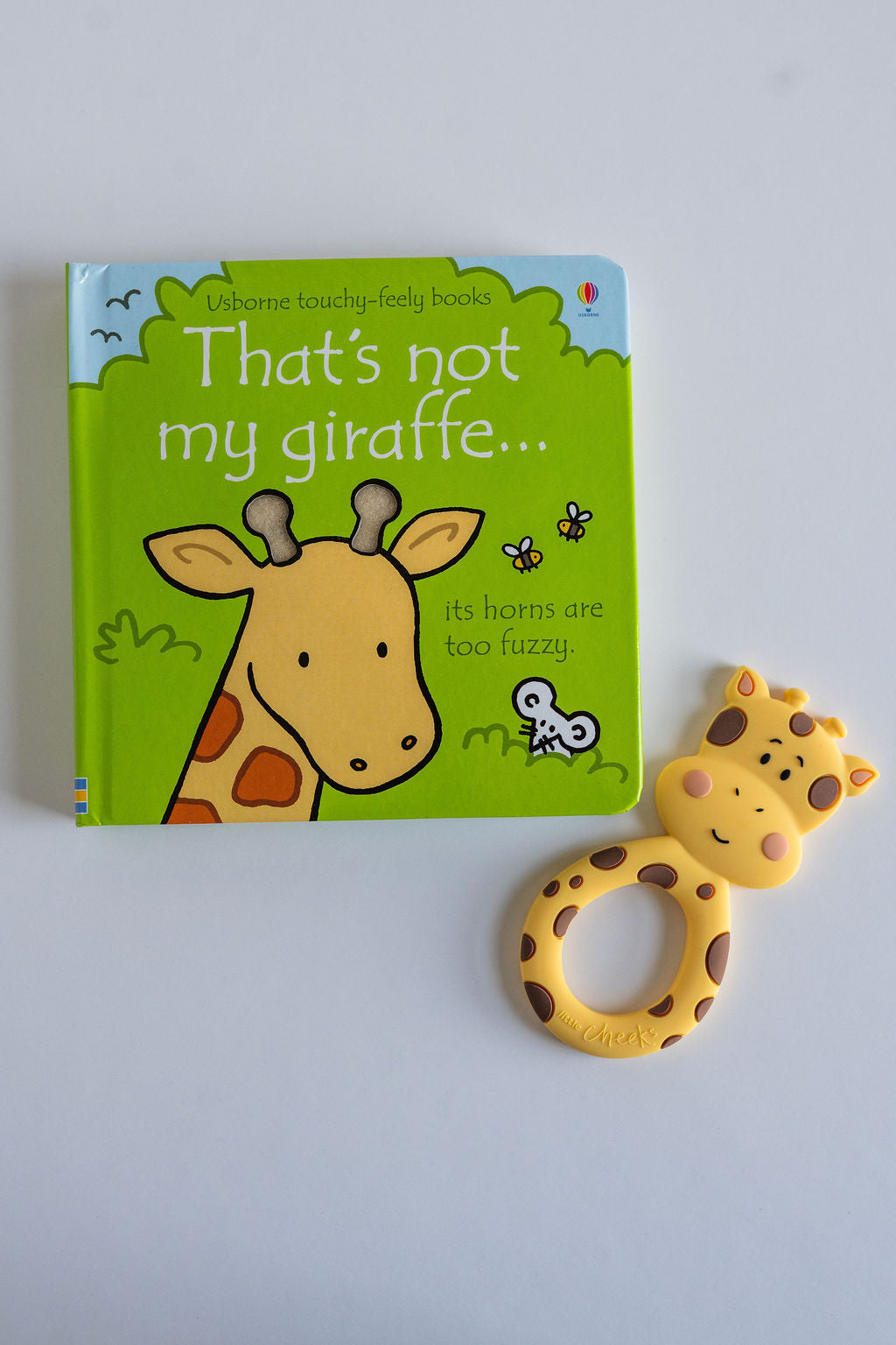 Geraldine the Giraffe teether and "That's not my" book